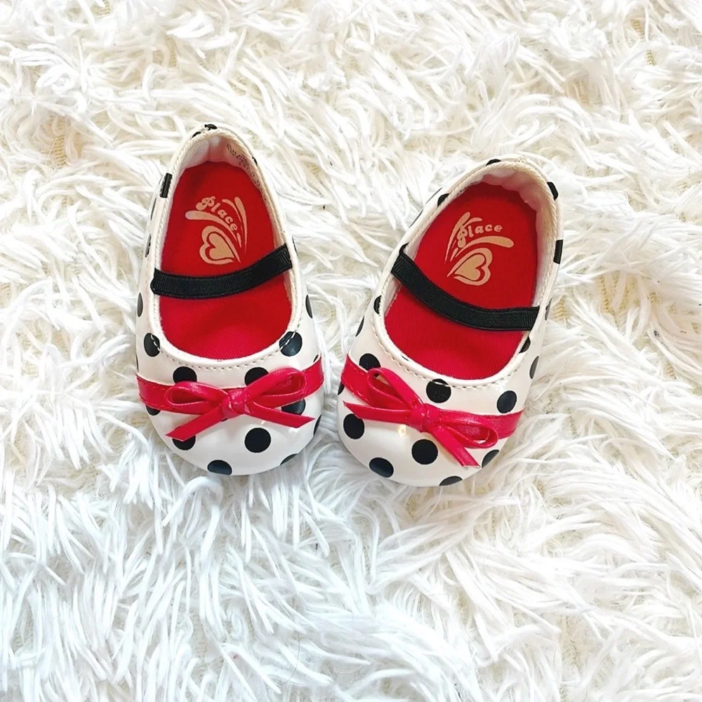 Place • Black and White Baby Polka Dot Mary Janes with Red Bow Accent Detailing